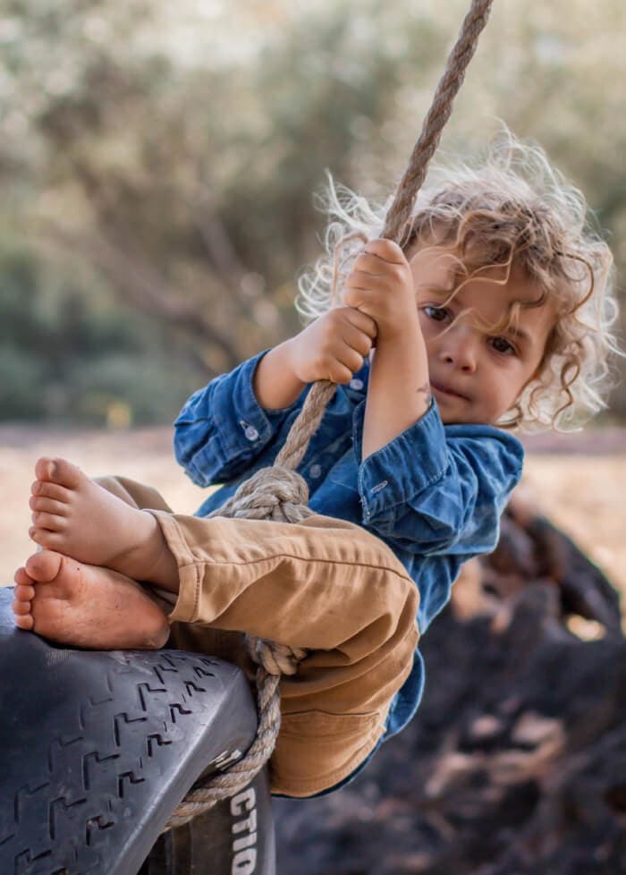 Young children engaged in outdoor nature-based learning activities